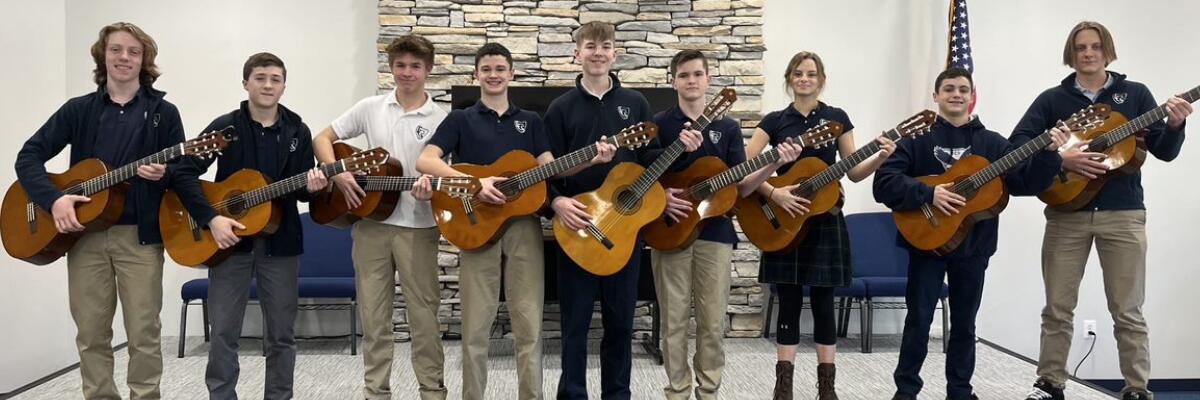 Photo of Students Holding Guitars