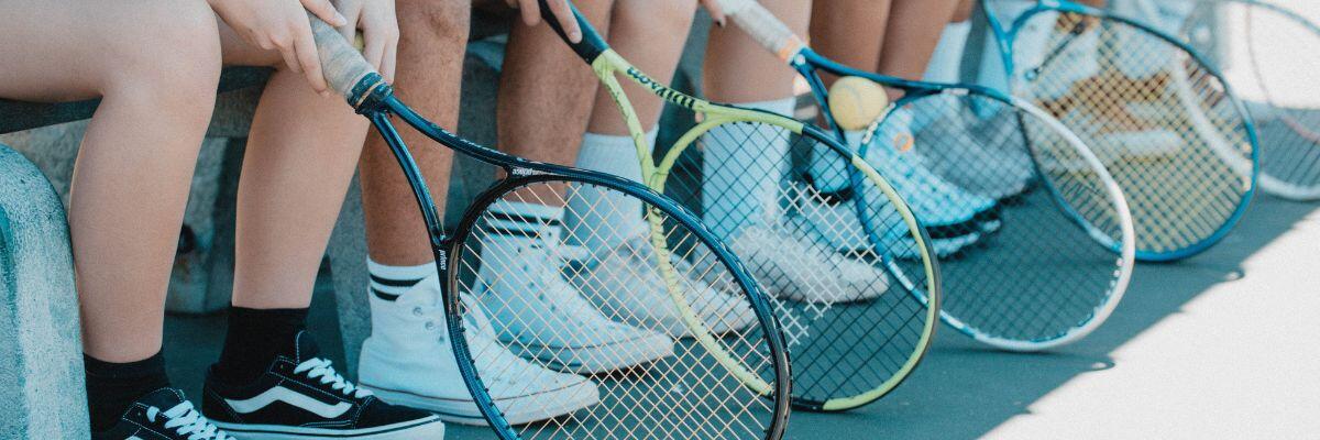 Tennis Rackets and Balls and Players Feet