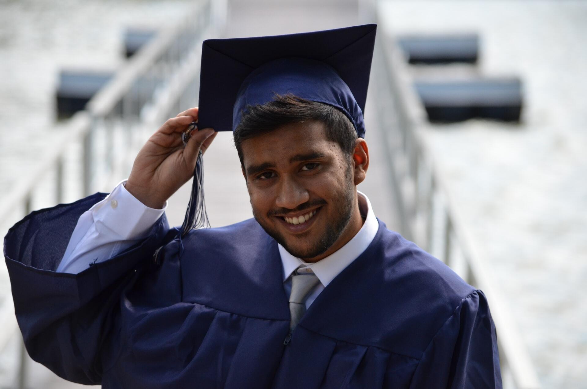 Male student in graduation cap and gown